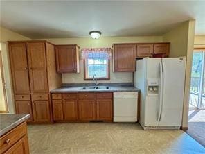 1984-2008 S Genesee St, Montour, NY 14865 - kitchen featuring white appliances, brown cabinetry, and a sink
