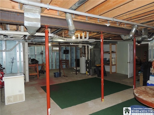 unfinished basement with gas water heater and heating unit