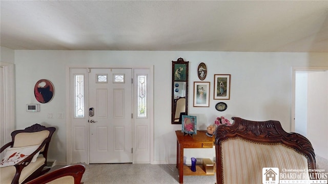 carpeted foyer with baseboards