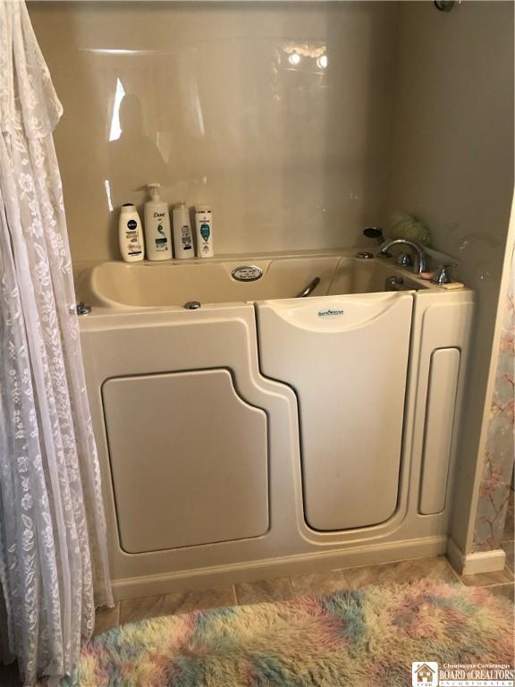 full bathroom with a bath