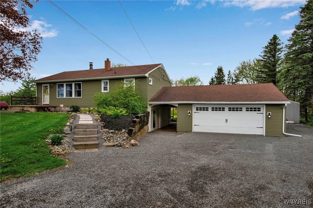 5069 Upper Mountain Rd, Cambria, NY 14094 - view of front of home with a chimney, a front lawn, and a garage
