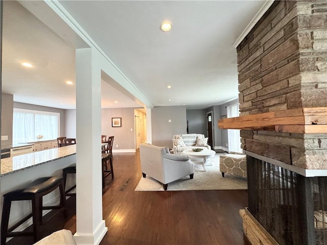 5 Walnut Street Ext, Sennett, NY 13021 - living room with dark wood-style floors, recessed lighting, a stone fireplace, and baseboards