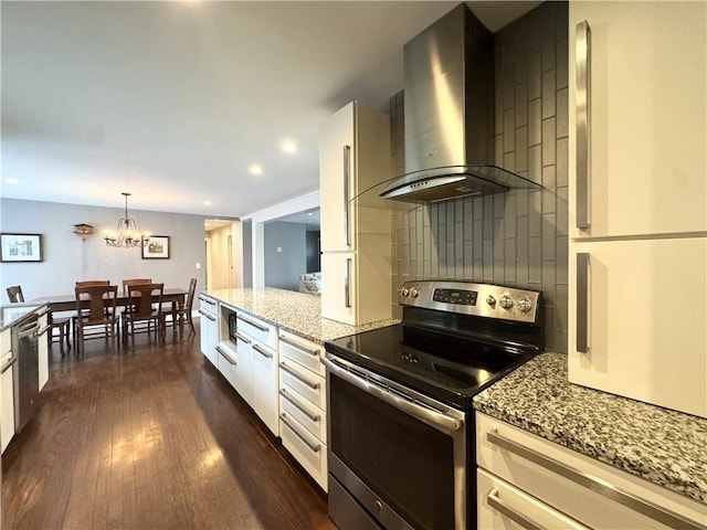 5 Walnut Street Ext, Sennett, NY 13021 - kitchen featuring stainless steel appliances, wall chimney range hood, light stone counters, dark wood-style flooring, and backsplash