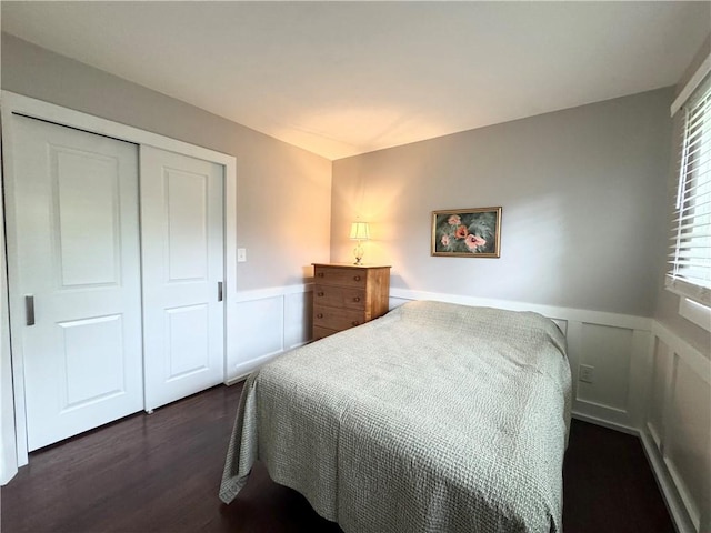 5 Walnut Street Ext, Sennett, NY 13021 - bedroom featuring wainscoting, a decorative wall, dark wood-style flooring, and a closet