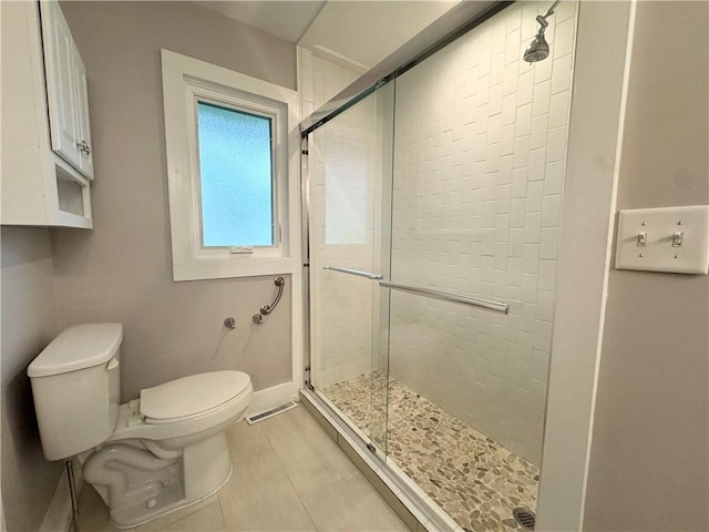 5 Walnut Street Ext, Sennett, NY 13021 - bathroom with a stall shower, toilet, tile patterned flooring, and baseboards