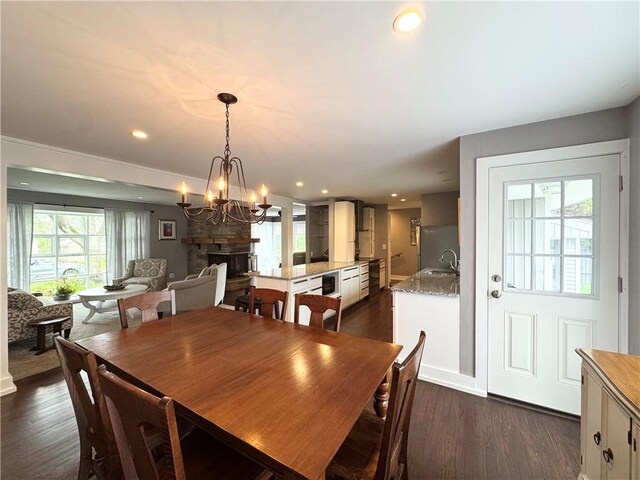 5 Walnut Street Ext, Sennett, NY 13021 - dining space with a chandelier, dark wood-type flooring, recessed lighting, and a stone fireplace