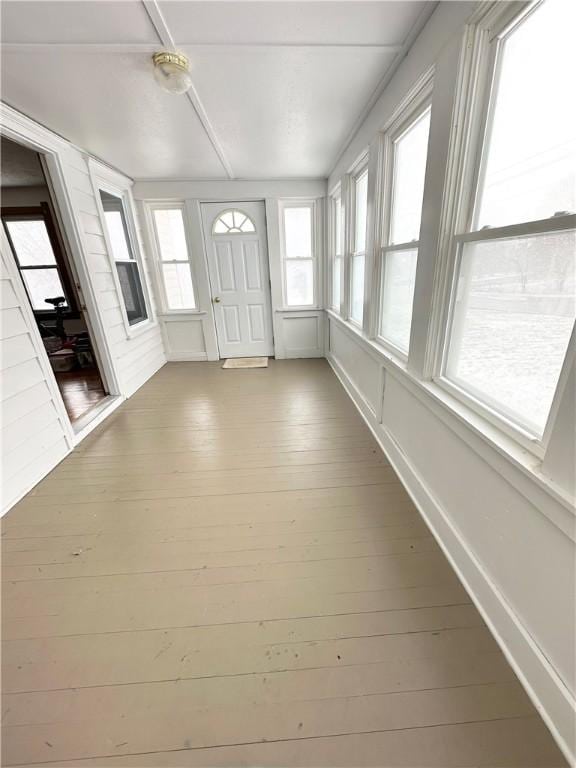 unfurnished sunroom with hardwood / wood-style flooring