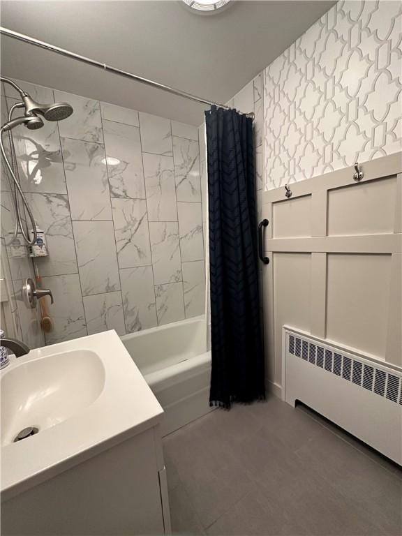 full bath featuring radiator, a sink, shower / bath combo with shower curtain, and wallpapered walls