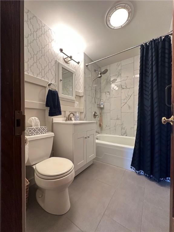 bathroom featuring tile patterned floors, shower / tub combo with curtain, toilet, and vanity