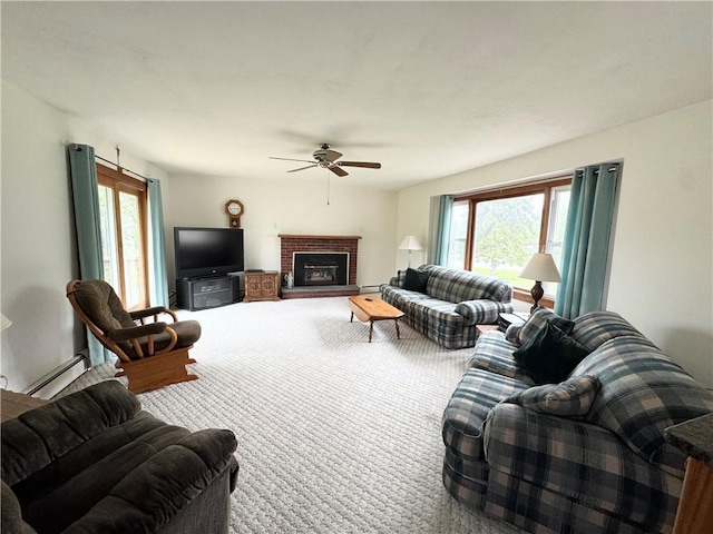 living area with a ceiling fan, healthy amount of natural light, carpet flooring, and a fireplace