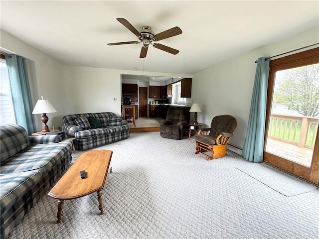 carpeted living room featuring ceiling fan