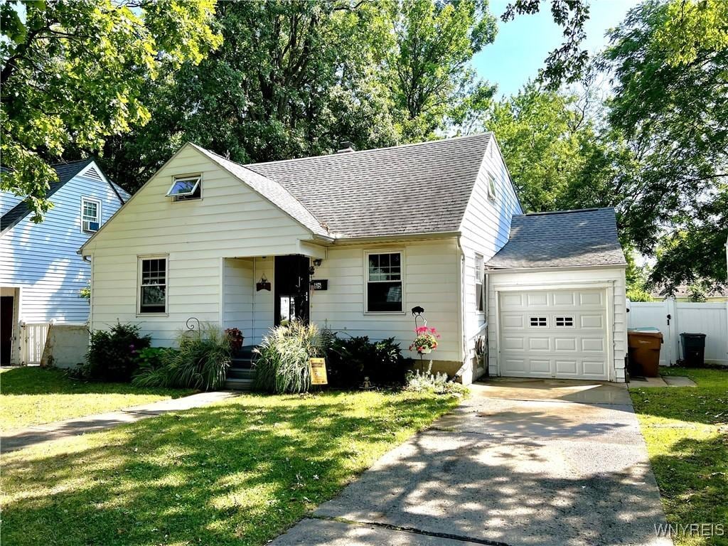 65 Woodridge Ave, Cheektowaga, NY 14225 - view of front of house with roof with shingles, asphalt driveway, and an attached garage