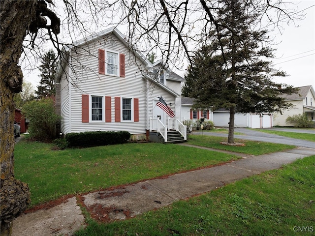 traditional home featuring a garage and a front lawn