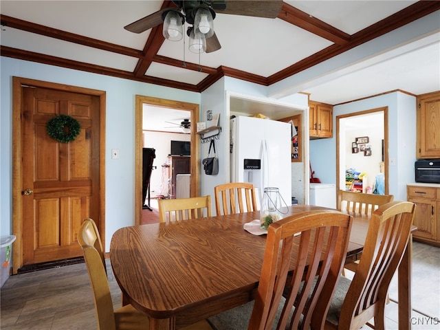 dining area with ceiling fan, coffered ceiling, ornamental molding, and light wood-style flooring