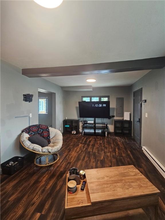 57 Interstate Pkwy, Bradford-City, PA 16701 - living area with wood finished floors, healthy amount of natural light, electric panel, and a baseboard heating unit