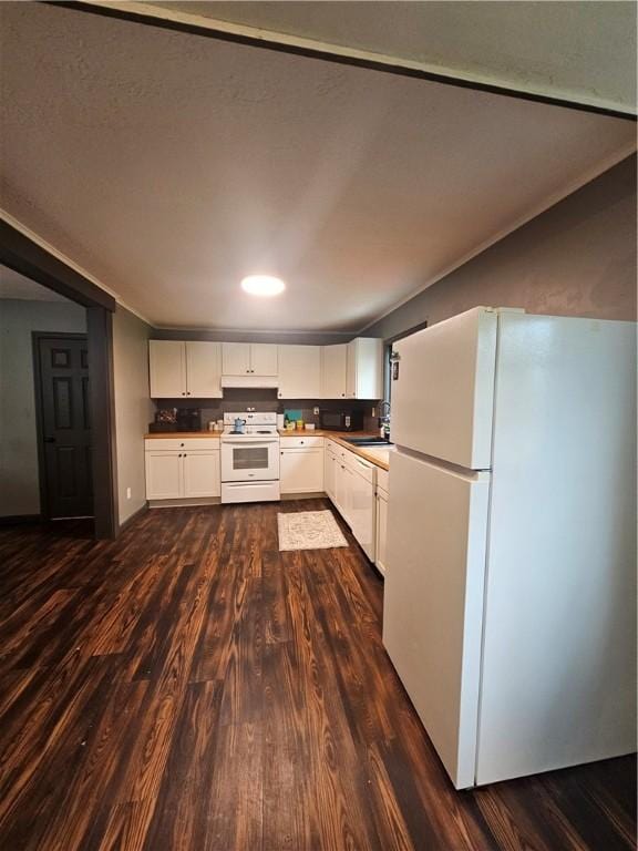 57 Interstate Pkwy, Bradford-City, PA 16701 - kitchen with white appliances, dark wood-style floors, white cabinets, under cabinet range hood, and a sink