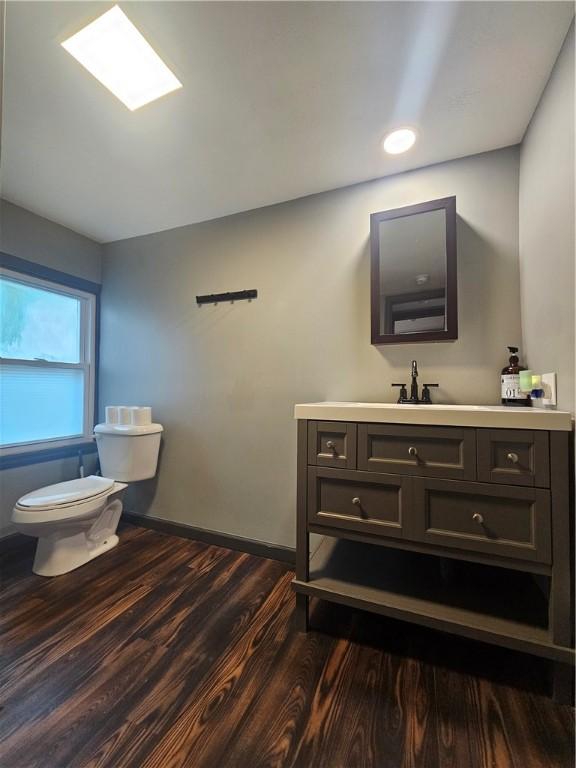 57 Interstate Pkwy, Bradford-City, PA 16701 - half bath featuring toilet, vanity, wood finished floors, and baseboards