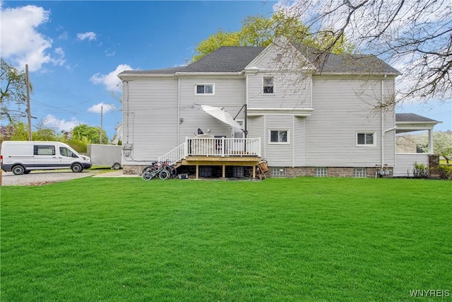 back of property with a yard and a wooden deck