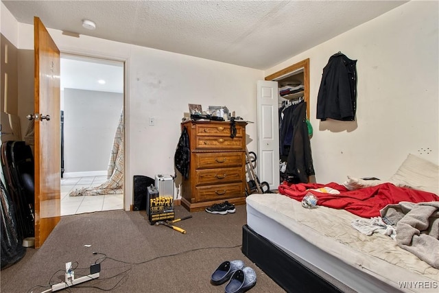 bedroom with a textured ceiling and a closet