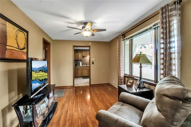401 Park Club Ln, Amherst, NY 14221 - living area featuring baseboards, a ceiling fan, and light wood-type flooring