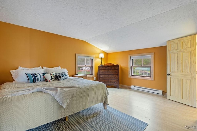 bedroom featuring a baseboard heating unit, wood finished floors, vaulted ceiling, and a textured ceiling