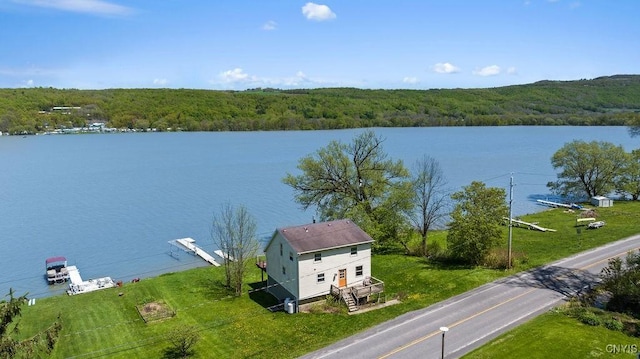 water view featuring a heavily wooded area and stairway