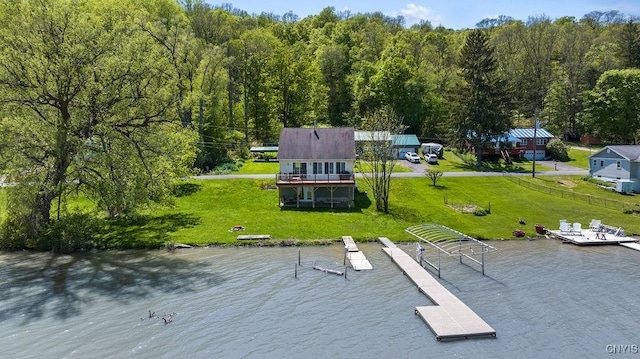 view of subject property featuring a nearby body of water and a forest