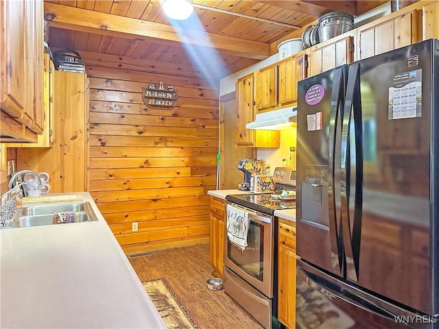2669 Town Line Rd, Mount Morris, NY 14517 - kitchen with black fridge with ice dispenser, stainless steel electric stove, under cabinet range hood, a sink, and wood ceiling with exposed beams