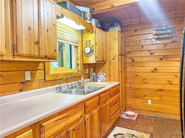 2669 Town Line Rd, Mount Morris, NY 14517 - kitchen featuring a sink, wooden ceiling with exposed beams, light countertops, wood walls, and wood finished floors