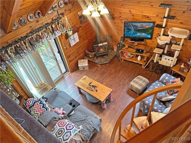 2669 Town Line Rd, Mount Morris, NY 14517 - living area with a wood stove, wood walls, wood finished floors, and a chandelier