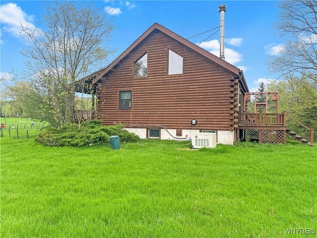 2669 Town Line Rd, Mount Morris, NY 14517 - view of side of home featuring log exterior, a deck, a yard, and central AC