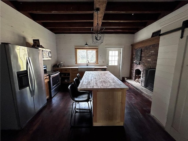 93 Main St, Laurens, NY 13796 - kitchen featuring stainless steel appliances, a sink, dark wood finished floors, beam ceiling, and a kitchen island