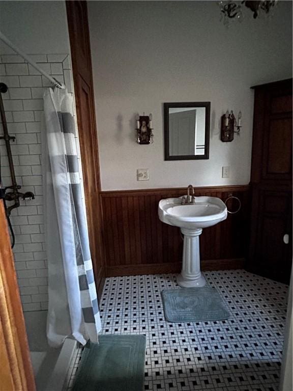 93 Main St, Laurens, NY 13796 - bathroom with wainscoting, a shower stall, and wood walls
