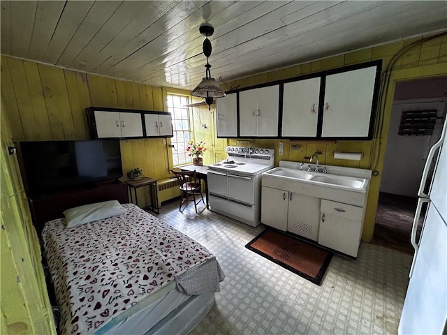 93 Main St, Laurens, NY 13796 - kitchen with white appliances, a sink, white cabinetry, wooden walls, and wood ceiling