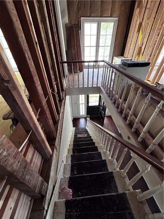 93 Main St, Laurens, NY 13796 - stairs with plenty of natural light and wood finished floors