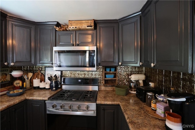 285 Clinton St, Gouverneur, NY 13642 - kitchen with appliances with stainless steel finishes, decorative backsplash, and dark countertops