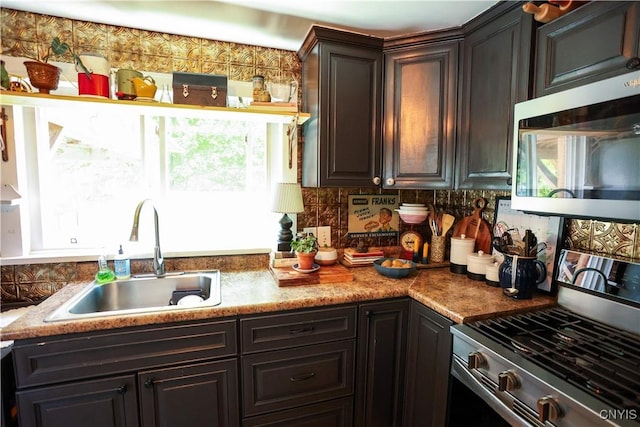 285 Clinton St, Gouverneur, NY 13642 - kitchen with appliances with stainless steel finishes, a sink, and backsplash
