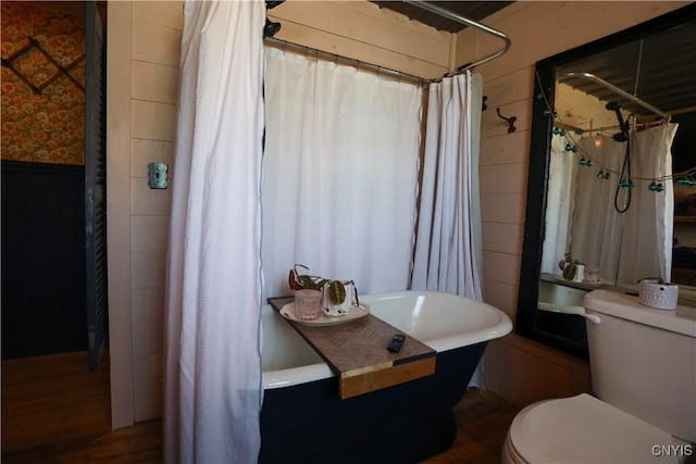 285 Clinton St, Gouverneur, NY 13642 - full bath featuring toilet, wainscoting, wood finished floors, wallpapered walls, and shower / bath combination with curtain