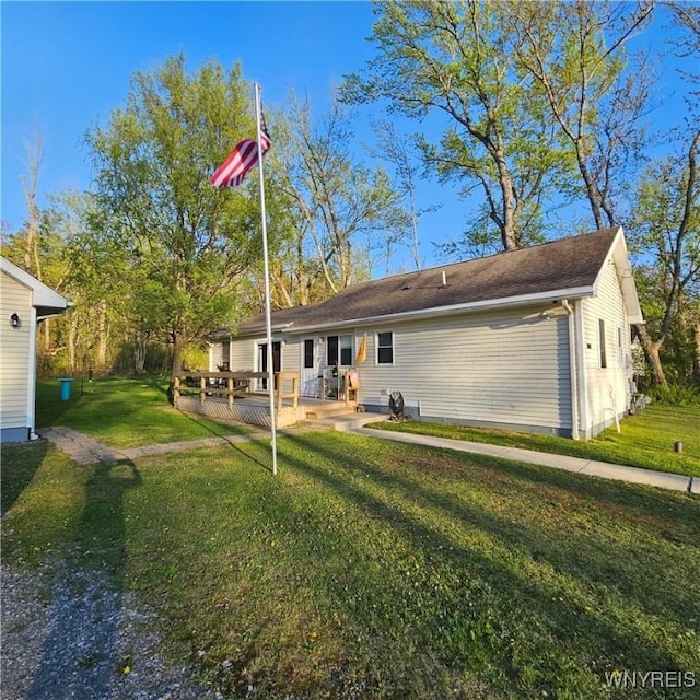 back of house featuring a yard and a deck