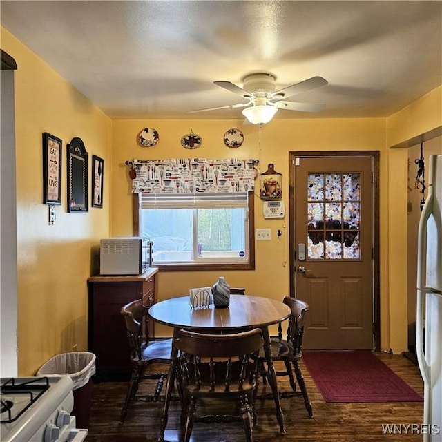 dining room featuring dark wood-type flooring and a ceiling fan