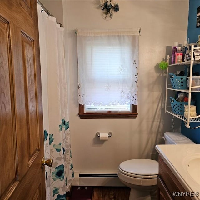 bathroom featuring toilet, vanity, a baseboard radiator, curtained shower, and wood finished floors