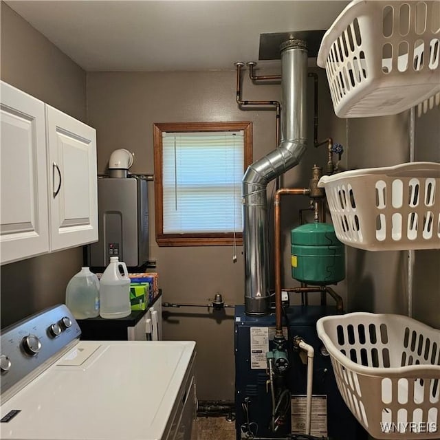 laundry room featuring washing machine and clothes dryer, cabinet space, water heater, and a heating unit