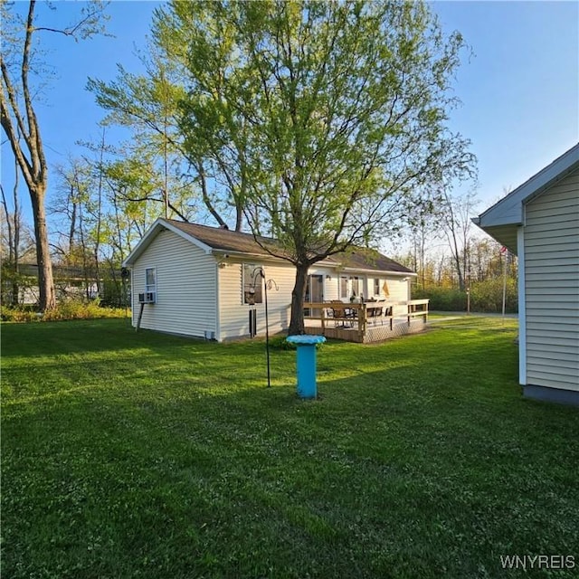 view of green lawn with a deck
