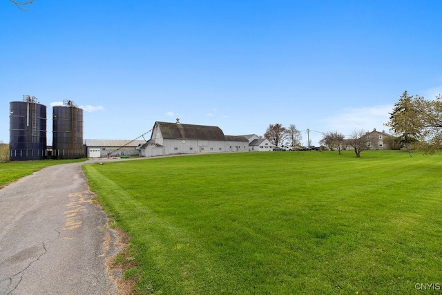 2066 Deerlick Rd, Cape Vincent, NY 13618 - view of front of house with asphalt driveway, an attached garage, and a front lawn
