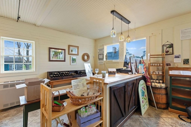 2066 Deerlick Rd, Cape Vincent, NY 13618 - kitchen with radiator heating unit, tile patterned flooring, and decorative light fixtures