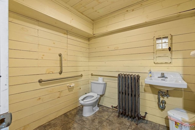 2066 Deerlick Rd, Cape Vincent, NY 13618 - bathroom with radiator heating unit, wood ceiling, toilet, wood walls, and tile patterned flooring