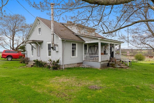 2066 Deerlick Rd, Cape Vincent, NY 13618 - view of front of house featuring covered porch, a shingled roof, and a front yard