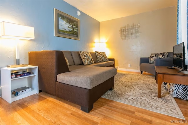 living room featuring wood finished floors and baseboards