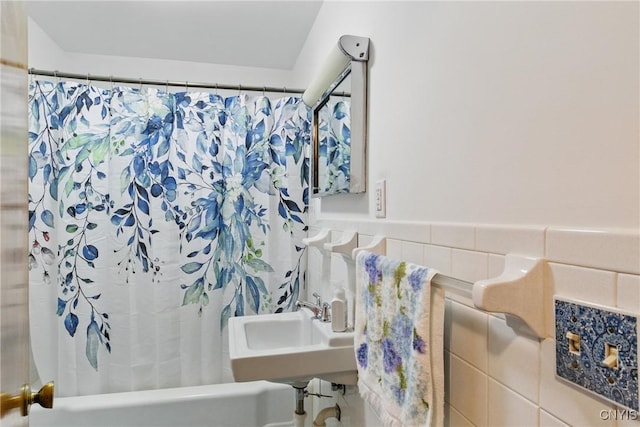 106 Lee Ter, Manlius, NY 13057 - bathroom with shower / bathtub combination with curtain, tile walls, a sink, and wainscoting