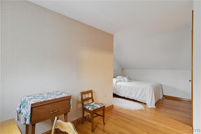 106 Lee Ter, Manlius, NY 13057 - bedroom featuring wood finished floors, baseboards, vaulted ceiling, and wallpapered walls
